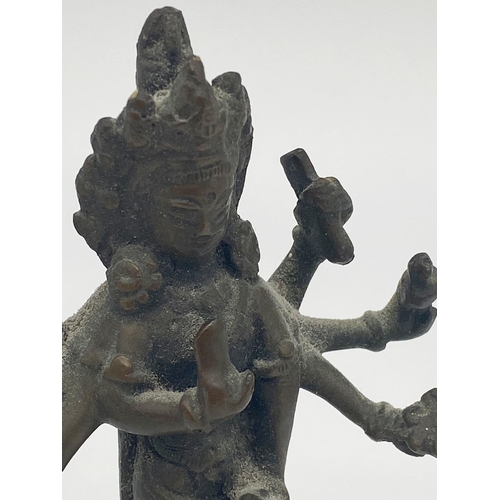 96 - Small antique Chinese bronze figure of a standing Buddhist Deity with eight arms, possibly Amoghapas... 