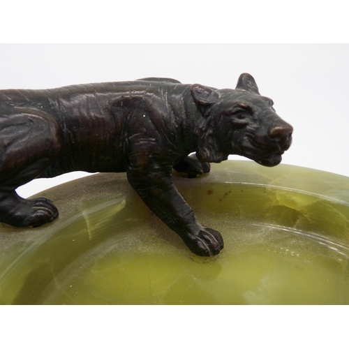 154 - Art deco green onyx ashtray mounted by a bronze tiger, 16cm long