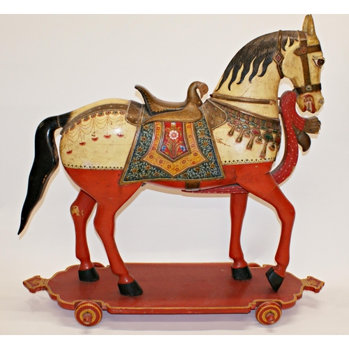 101 - Good quality Indian folk art carved wooden horse on wheels, with hand painted decoration, 82 x 86cm