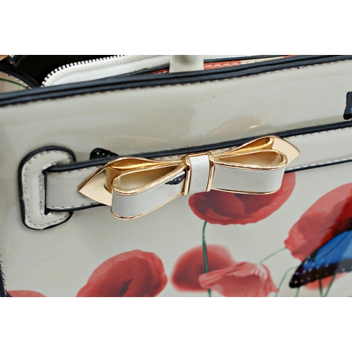 498 - Ted Baker Butterfly and poppy pattern bag and purse, the bag 27 x 34cm