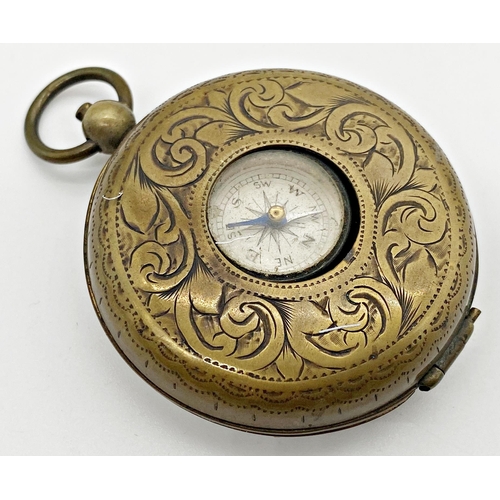 427 - Early 20th century brass cased pocket compass and telescopic drinking cup, 50mm case inscribed verso... 