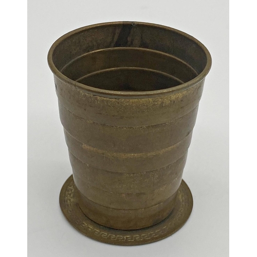 427 - Early 20th century brass cased pocket compass and telescopic drinking cup, 50mm case inscribed verso... 