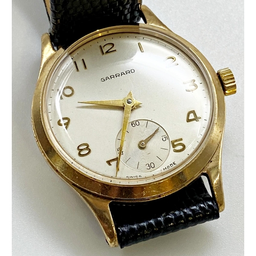 411 - Vintage Garrard 9ct gold mid size wristwatch, 30mm case, champagne dial with gilt hands and Arabic n... 