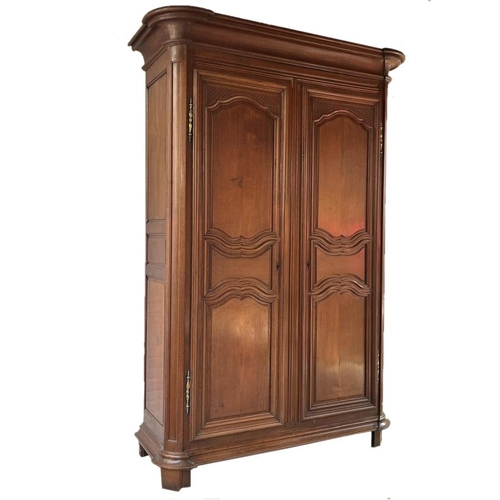 580 - Massive 19th century French fruitwood armoire, moulded cornice over fancy panelled doors enclosing a... 