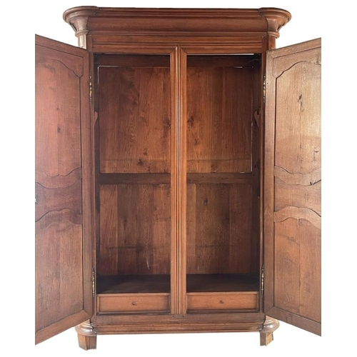 580 - Massive 19th century French fruitwood armoire, moulded cornice over fancy panelled doors enclosing a... 