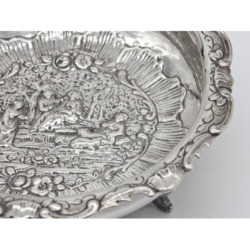 192 - Late Victorian import silver pedestal dish, centrally embossed with a romantic garden scene, maker W... 