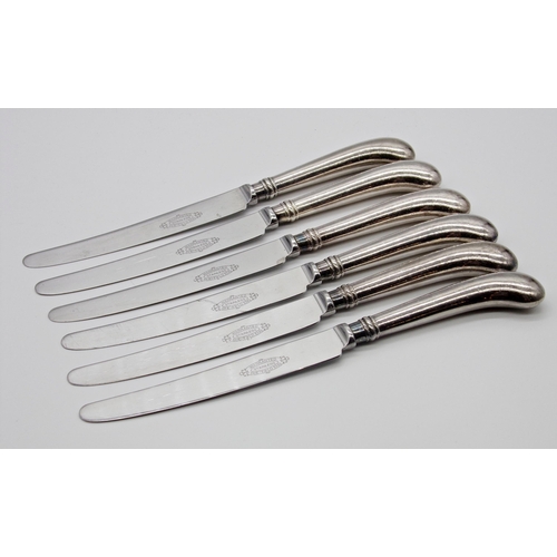 225 - Set of six white metal handled pistol grip table knives with stainless blades, 24.25cm long (unmarke... 