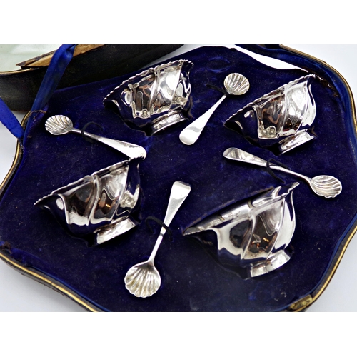 237 - Cased set of four late Victorian Irish silver wrythen fluted salts, with matching spoons, maker West... 