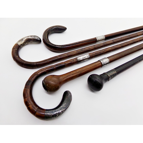 136 - Five silver applied walking canes