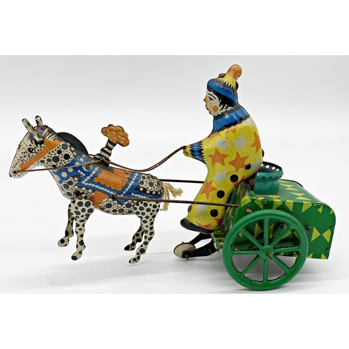 180 - German tinplate windup toy of a clown on a horse drawn cart 19cm long