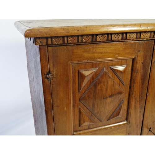 527 - 18th century Italian walnut cupboard, geometric panelled doors enclosing a shelved interior on paw f... 