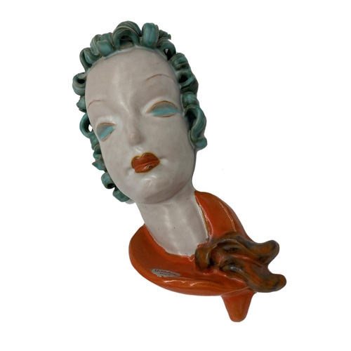 14 - Goldscheider pottery face mask, with curled green hair and orange scarf, 29cm high