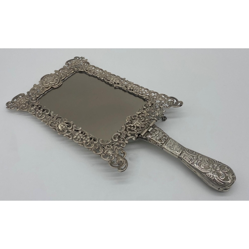 37 - Remarkable late Victorian silver hand / easel mirror, the frame pierced with hinged handle, pierced ... 