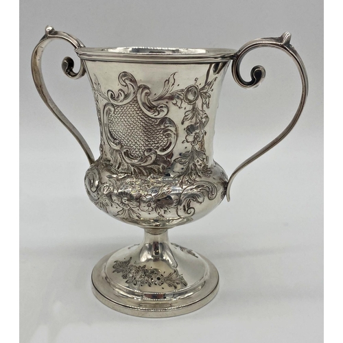 63 - Georgian white metal twin handled cup, with later Victorian chasing, no hallmarks present, 17cm high... 