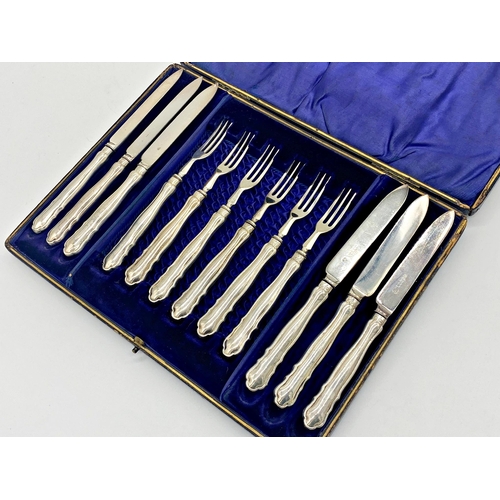 107 - Cased silver handled fruit knife and fork canteen for six, hallmarks worn