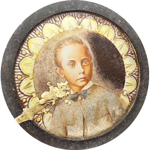 532 - Pair of 19th century painted glass panels of a young boy and girl, within iron mounts, 15.5cm diamet... 