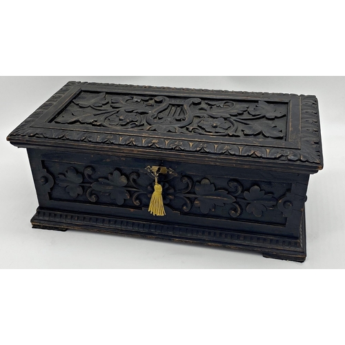 312 - Late 19th century Swiss carved music box, the lid carved with lyre and scrolled foliage in a darted ... 