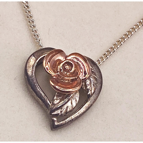 203 - Clogau pendant on a fine chain in the form of a heart with a central rose, housed within the origina... 