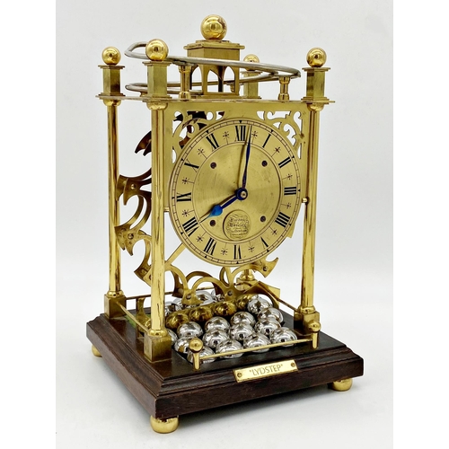 305 - Patent spherical weight clock by Harding & Bazeley of Cheltenham, surmounted by a track delivering s... 