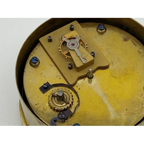 306 - A simple French brass drum head movement, enamel dial with Roman numerals, 9.5cm diameter