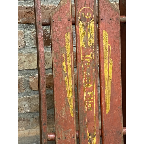 1003 - A flexible flyer American sledge, the timber top upon an iron frame, 103cm long together with a furt... 