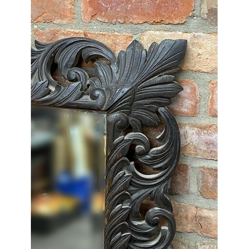 1194 - Late 19th century carved wall mirror, the stained oak frame with scrolled acanthus and scallop shell... 