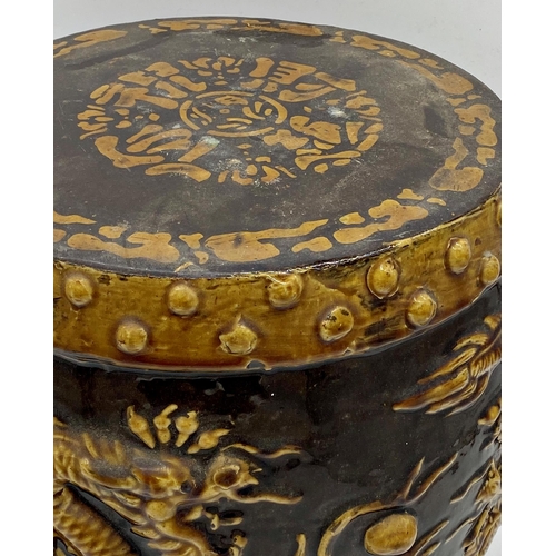 508 - Early 20th century Chinese pottery barrel stool decorated in relief with pearl chasing coiled dragon... 