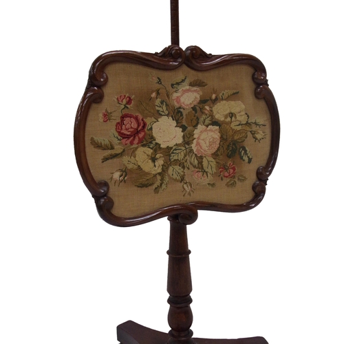 1131 - Regency mahogany pole screen, fitted with a floral wool work tapestry panel, 142cm high