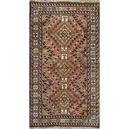 1092 - Turkish rug, green medallions on a washed red ground, 210 x 110.