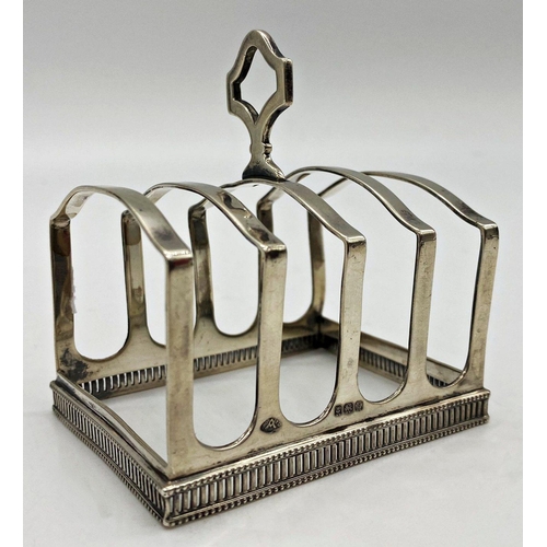 29 - Good 1930s silver four divisional toast rack, serpentine brackets on a pierced and beaded base, make... 