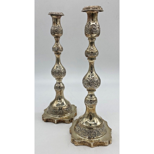 42 - A pair of George V silver Sabbath candlesticks, with knopped stems, raised on a shaped platform base... 