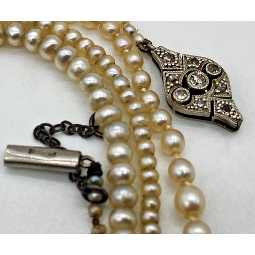 187 - An antique string of graduated seed peals with a Diamond set clasp stamped to the reverse 18ct Plat.... 