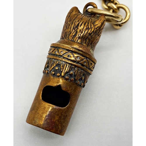 196 - A curb link chain stamped 18 together with a novelty metal whistle in the form of a cat wearing a bo... 