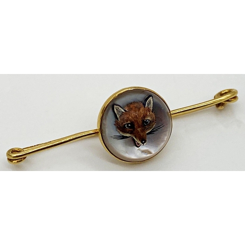 183 - A 9ct gold bar brooch, the central panel set with a painted and intaglio carved Essex crystal depict... 