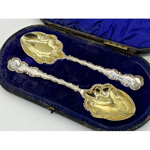 41 - Case pair of quality Edwardian serving spoons, cast scrolled rims and gilt bowls, maker Lee & Wigful... 