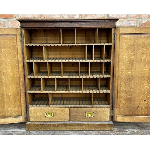 1393 - Victorian Gothic oak panelled pigeon hole cabinet, twin panelled doors enclosing a fitted interior w... 