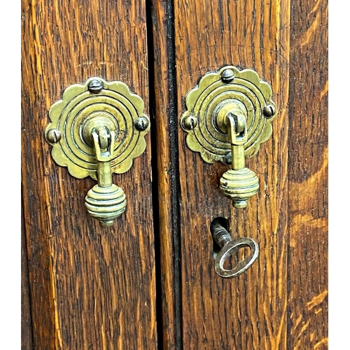 1393 - Victorian Gothic oak panelled pigeon hole cabinet, twin panelled doors enclosing a fitted interior w... 