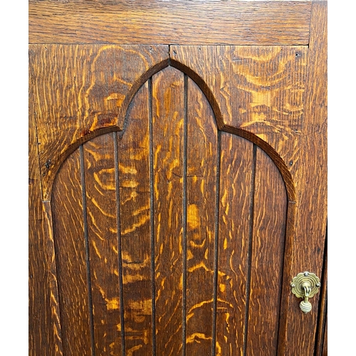 1393 - Victorian Gothic oak panelled pigeon hole cabinet, twin panelled doors enclosing a fitted interior w... 