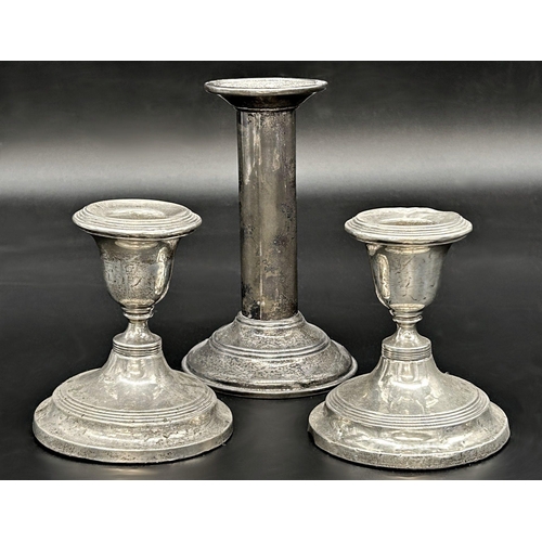 61 - Pair of Edwardian silver dwarf candlesticks with a further silver candlestick (3)