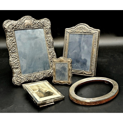 75 - Three embossed silver easel frames, 21 x 15cm, 17 x 12cm x 8.5 x 6cm with further plain examples (5)