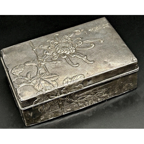 86 - Japanese hammered silver cigarette box, embossed with a lotus flower, hardwood lined interior, 15cm ... 