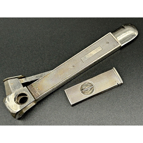 112 - Two engine turned silver cigar cutters, 15 & 5.5cm long