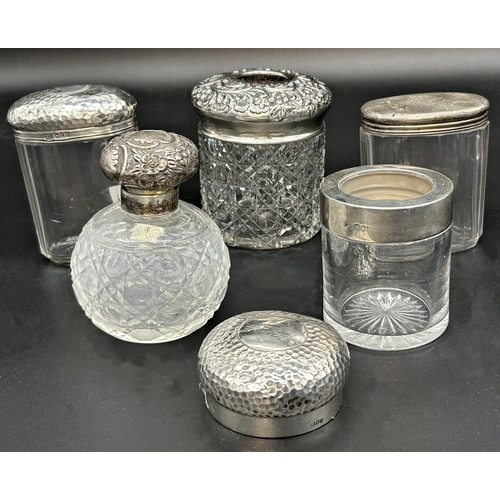 120 - Five silver topped dressing jars, with a further silver lid (6)