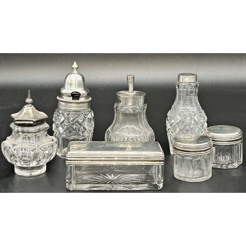 121 - Seven silver topped glass jars (7)