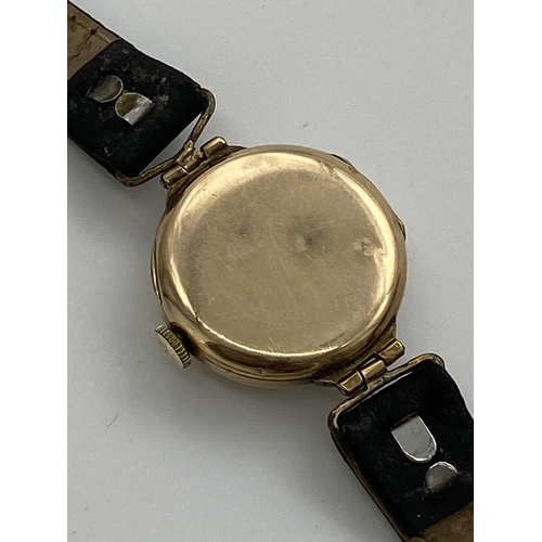 341 - 1930s 9ct dress watch, 25mm case, silvered dial, Arabic numerals, hinged lugs and leather strap, man... 