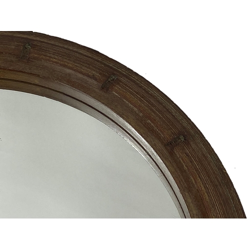 1289 - Teak Bearing Housing Royal Navy framed wall mirror, 70cm diameter