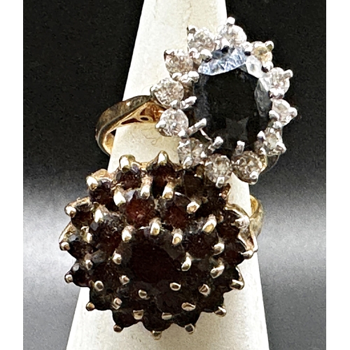 311 - 9ct sapphire and white stone cluster ring, size K, with a further 9ct and garnet cluster dress ring,... 