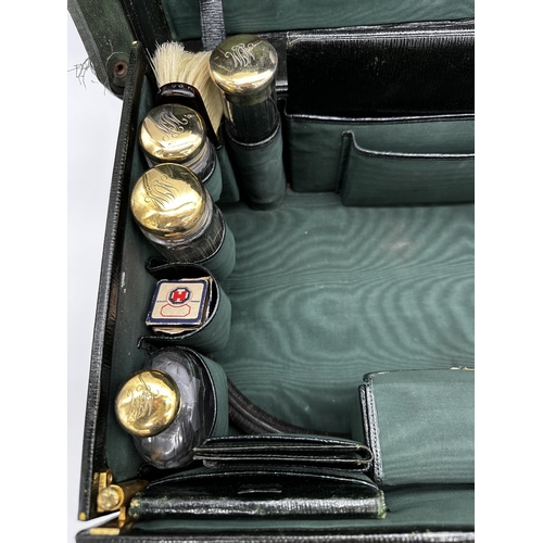 188 - Exceptional quality Edwardian racing green leather vanity case, with canvas protector, enclosing eig... 