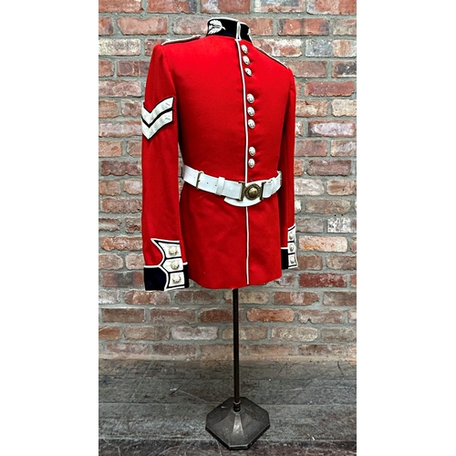 1253 - Vintage Scott's Guard red tunic uniform, with buttons and belt, upon a mannequin stand, 137cm high i... 