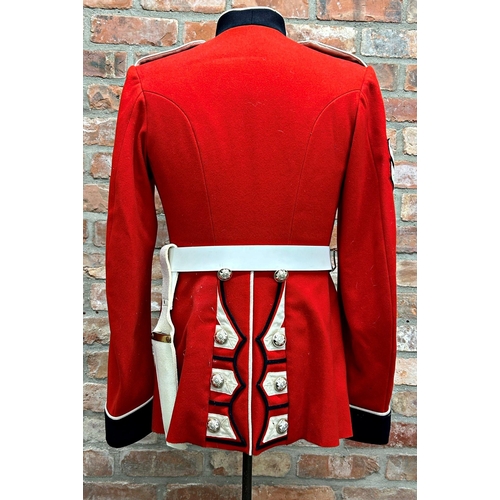 1253 - Vintage Scott's Guard red tunic uniform, with buttons and belt, upon a mannequin stand, 137cm high i... 